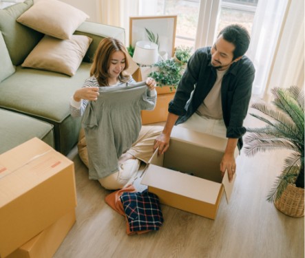 man and girl unpacking box