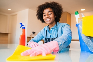 Cleaning empty kitchen cabinets and stove following a move in cleaning checklist