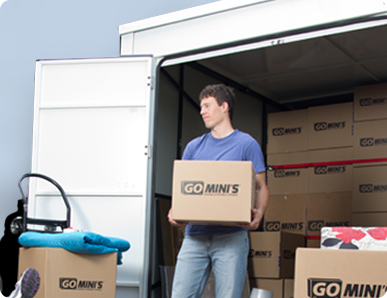Man loading a Go Mini's container with boxes
