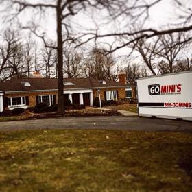 go minis unit on driveway with brown house