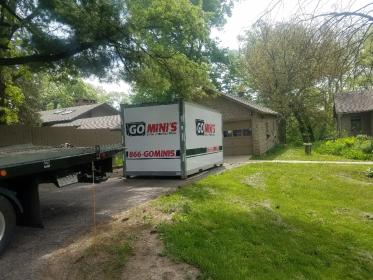 go minis unit on driveway with lawn and truck